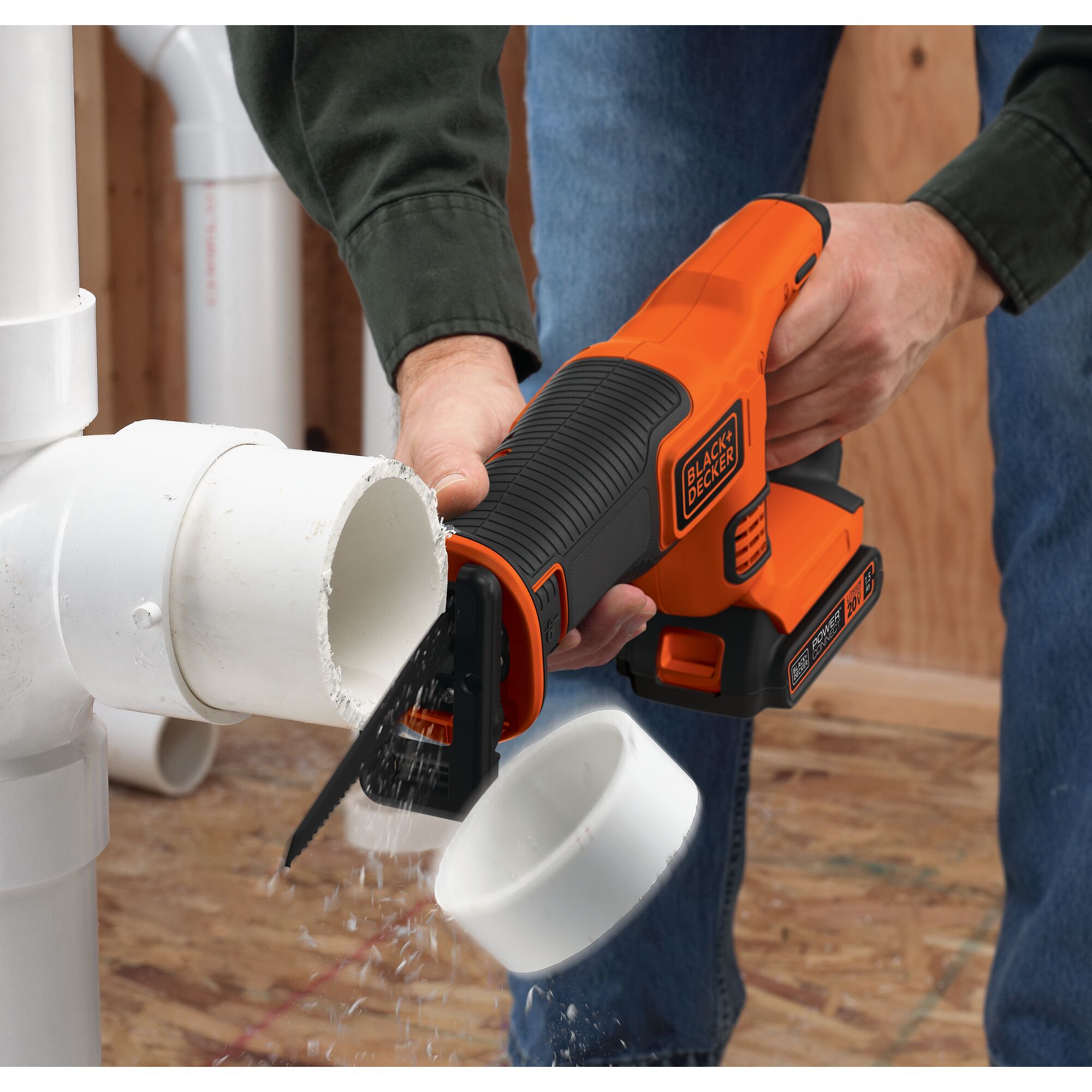 Black and decker 20 volt max lithium ion reciprocating saw being used to cut PVC
