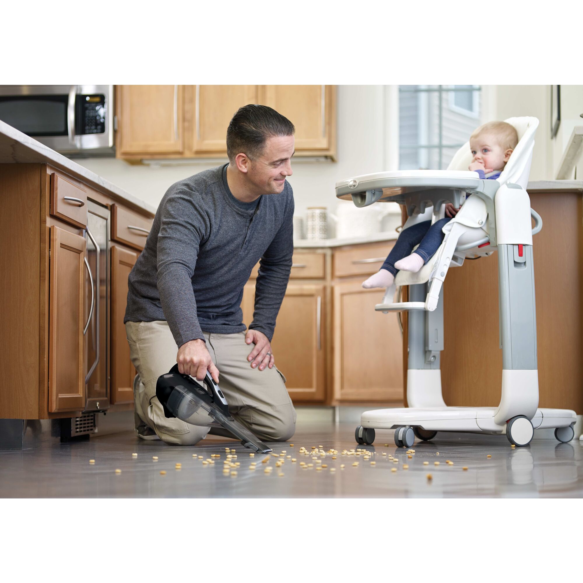 dustbuster AdvancedClean cordless hand vacuum being used by a person to clean food spillage.