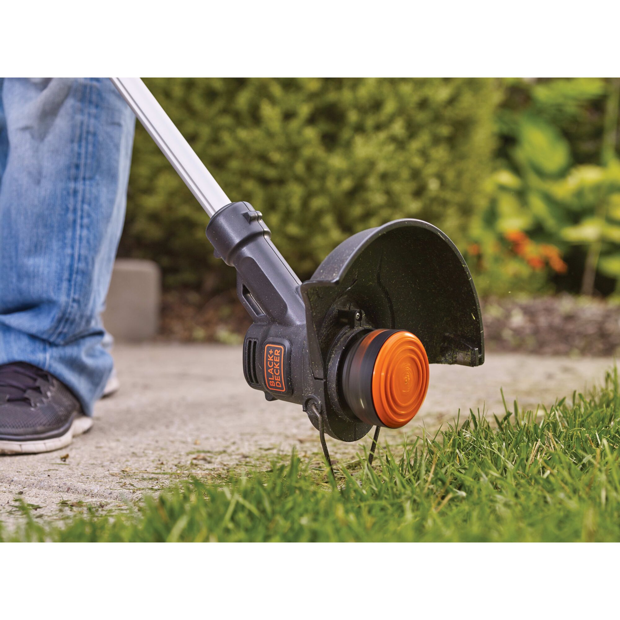 Close-up of the 20V Max Lithium 10 In. String Trimmer / Edger being used as an edger along a sidewalk.