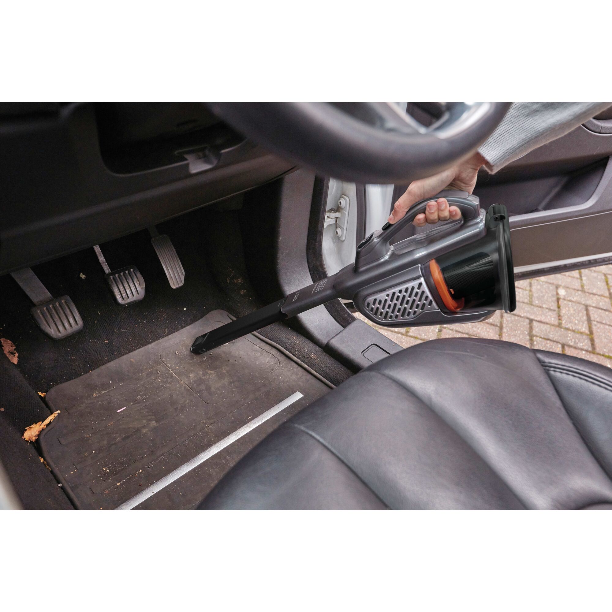 16 volt MAX dustbuster Advanced Clean Hand Vacuum being used to clean car mat.