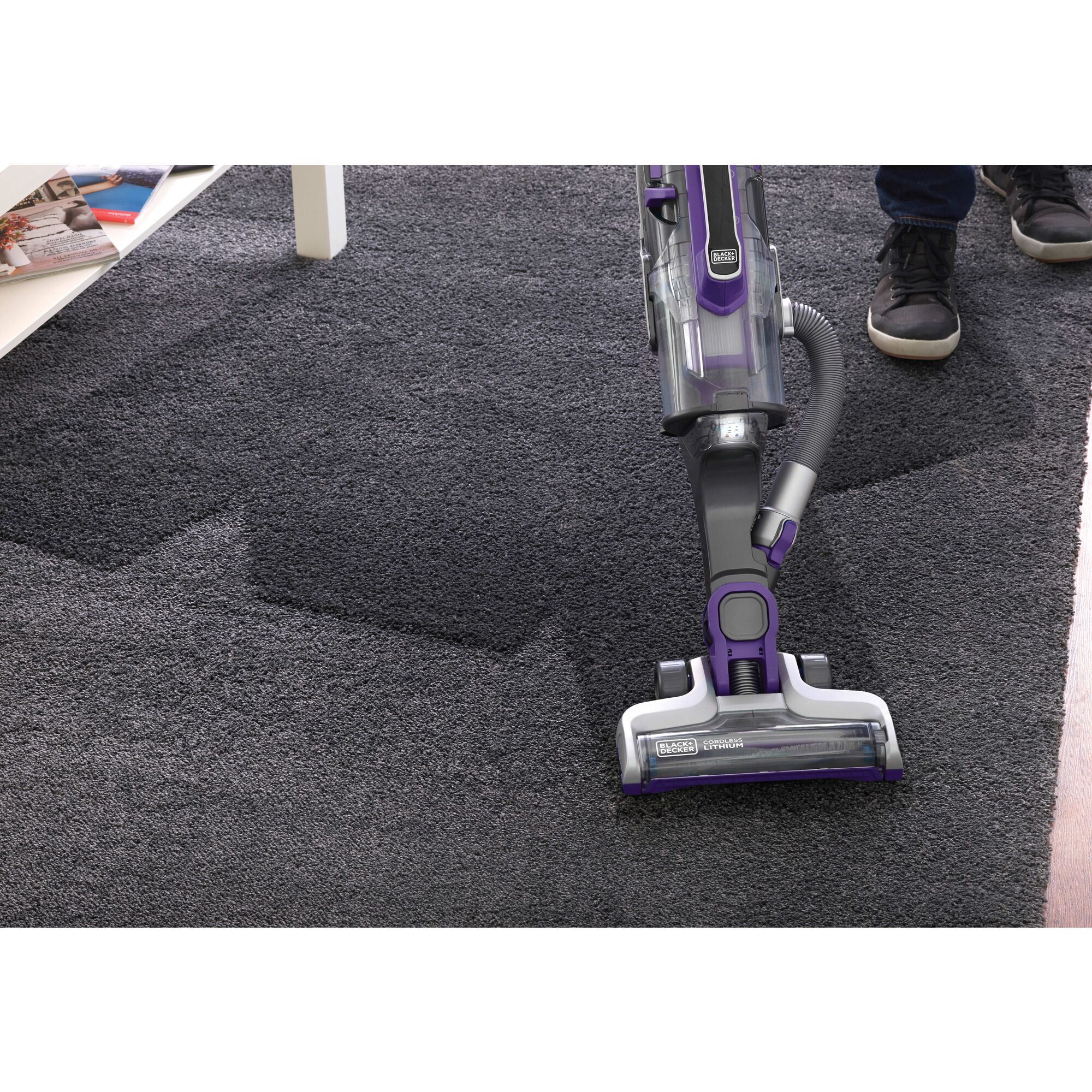 POWERSERIES PRO cordless 2 in 1 pet vacuum being used by a person to clean carpet.