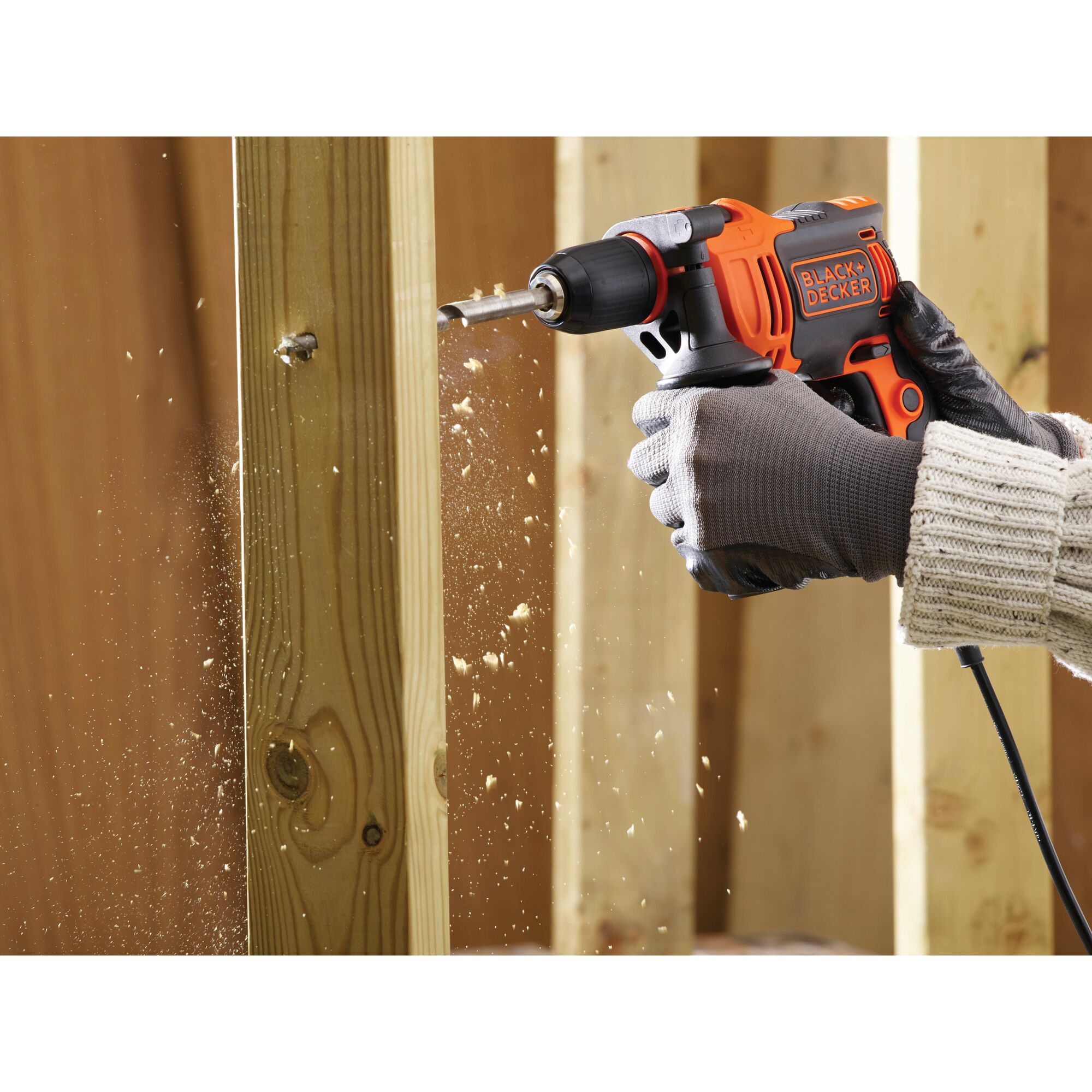 6 and a half Amp and half inch Hammer Drill being used to drill holes in a wooden structure.