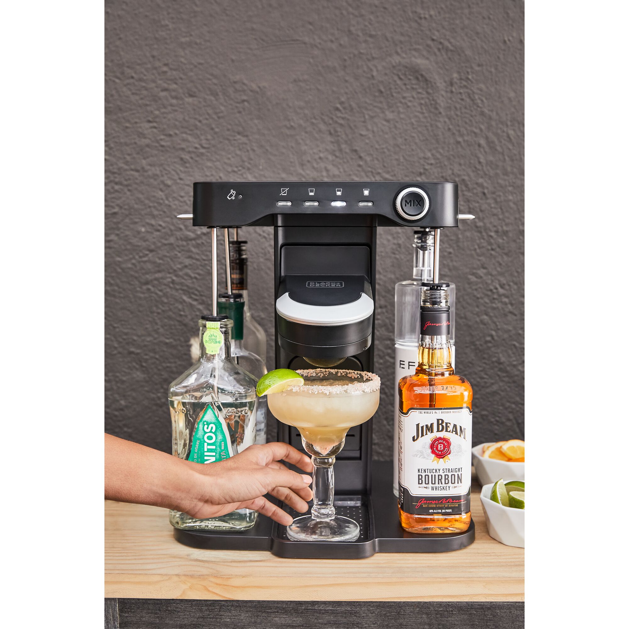 close-up, on the patio, of a woman's hand grabbing her margarita from the bev by BLACK+DECKER\u2122 cocktail maker