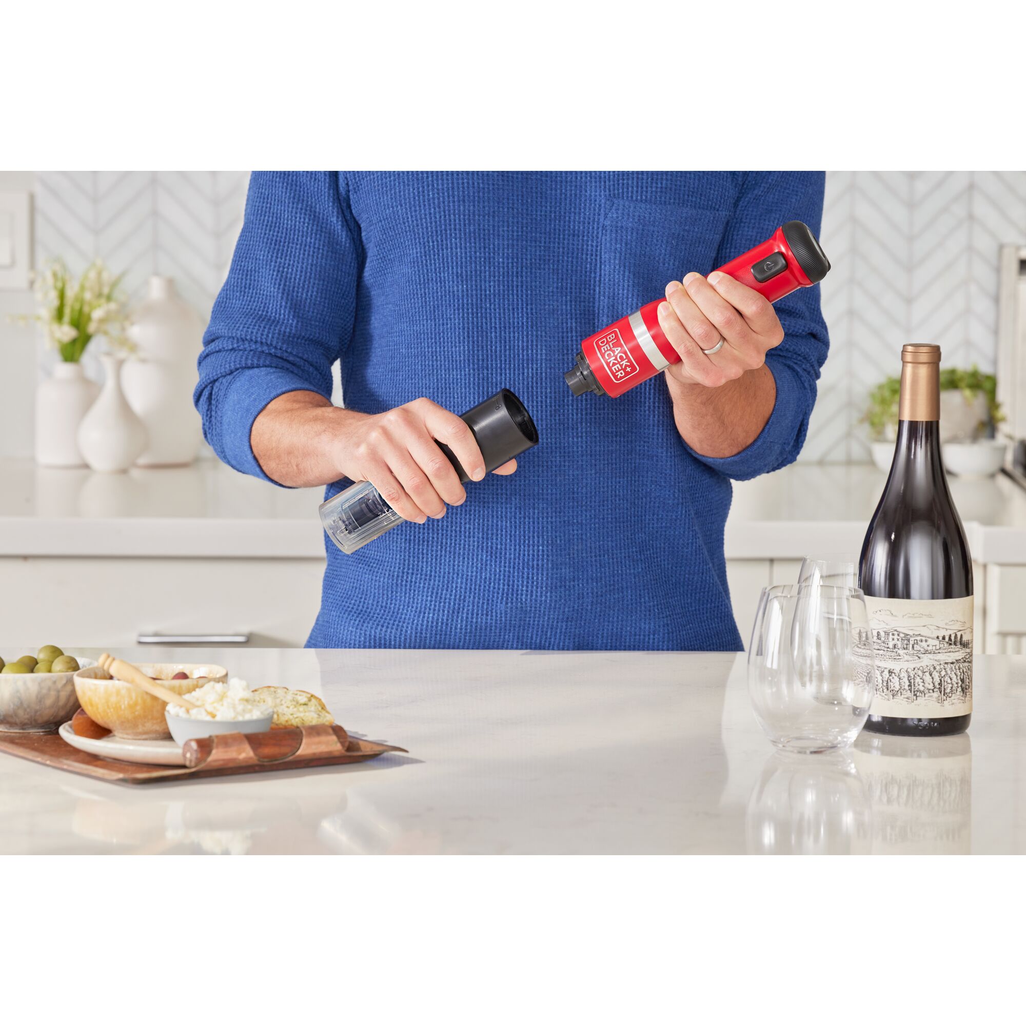 Talent showing how to attach the BLACK+DECKER kitchen wand wine opener attachment to the red power unit
