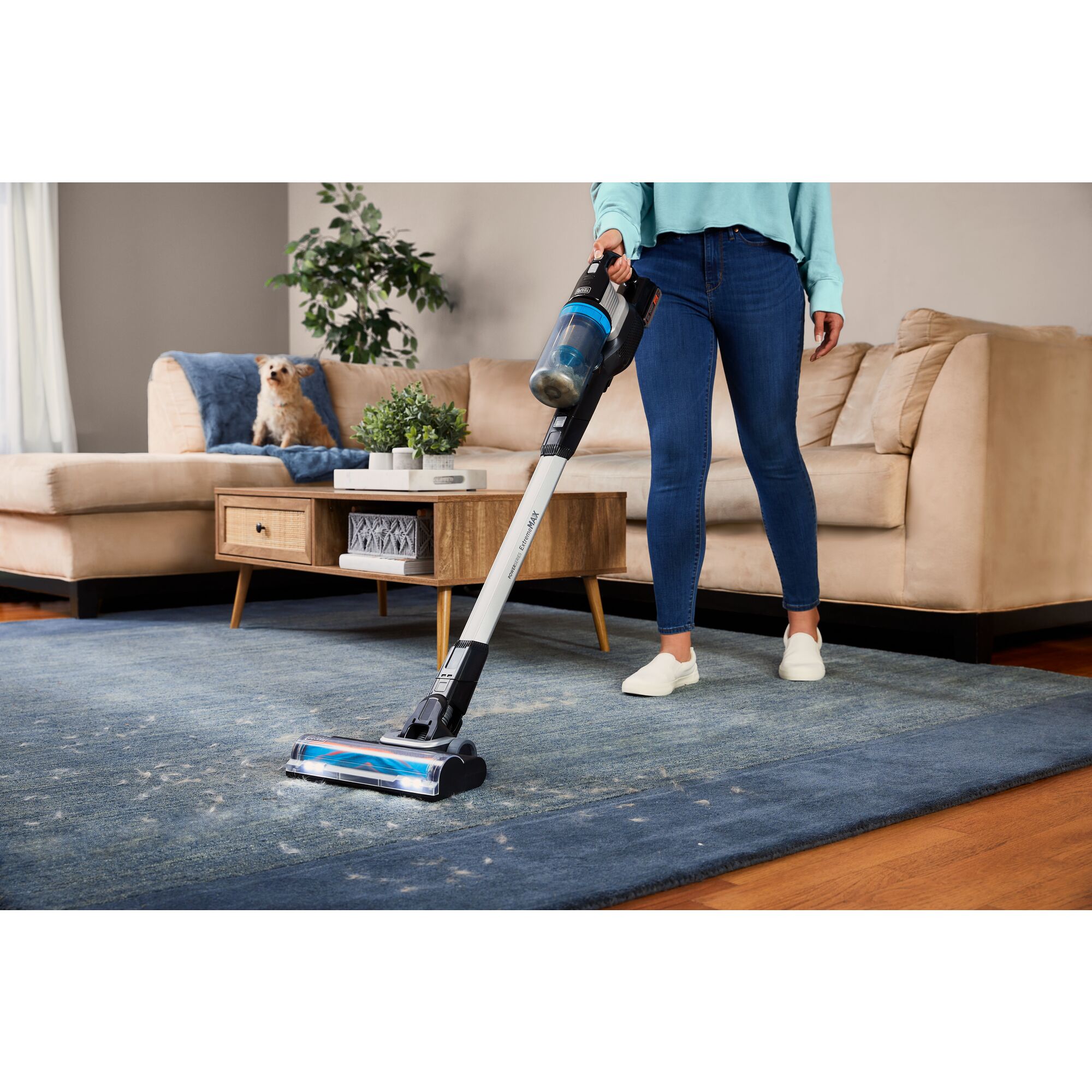 Woman vacuuming up dog hair with the POWERSERIES Extreme MAX cordless stick vac
