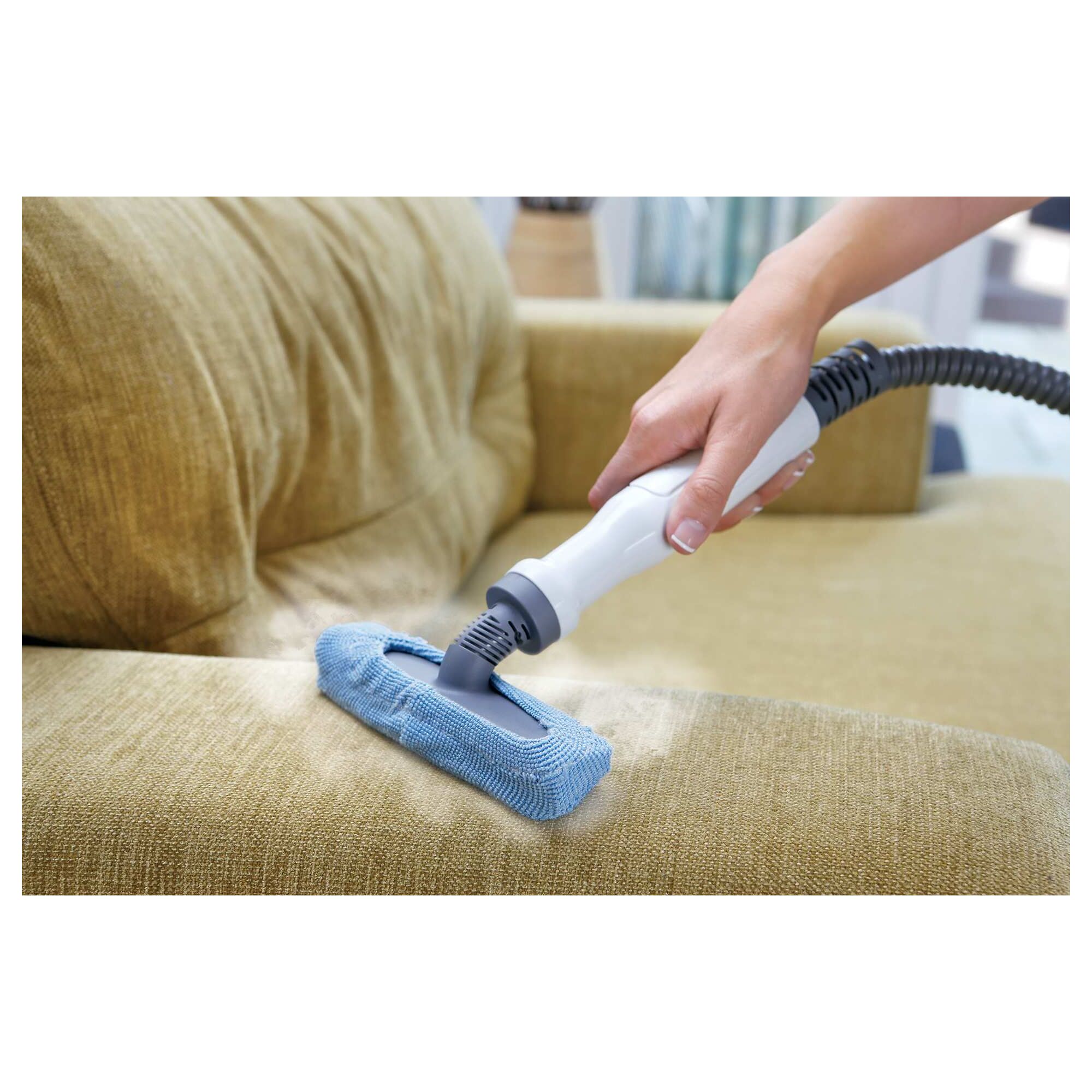 Portable steamer being used on a couch