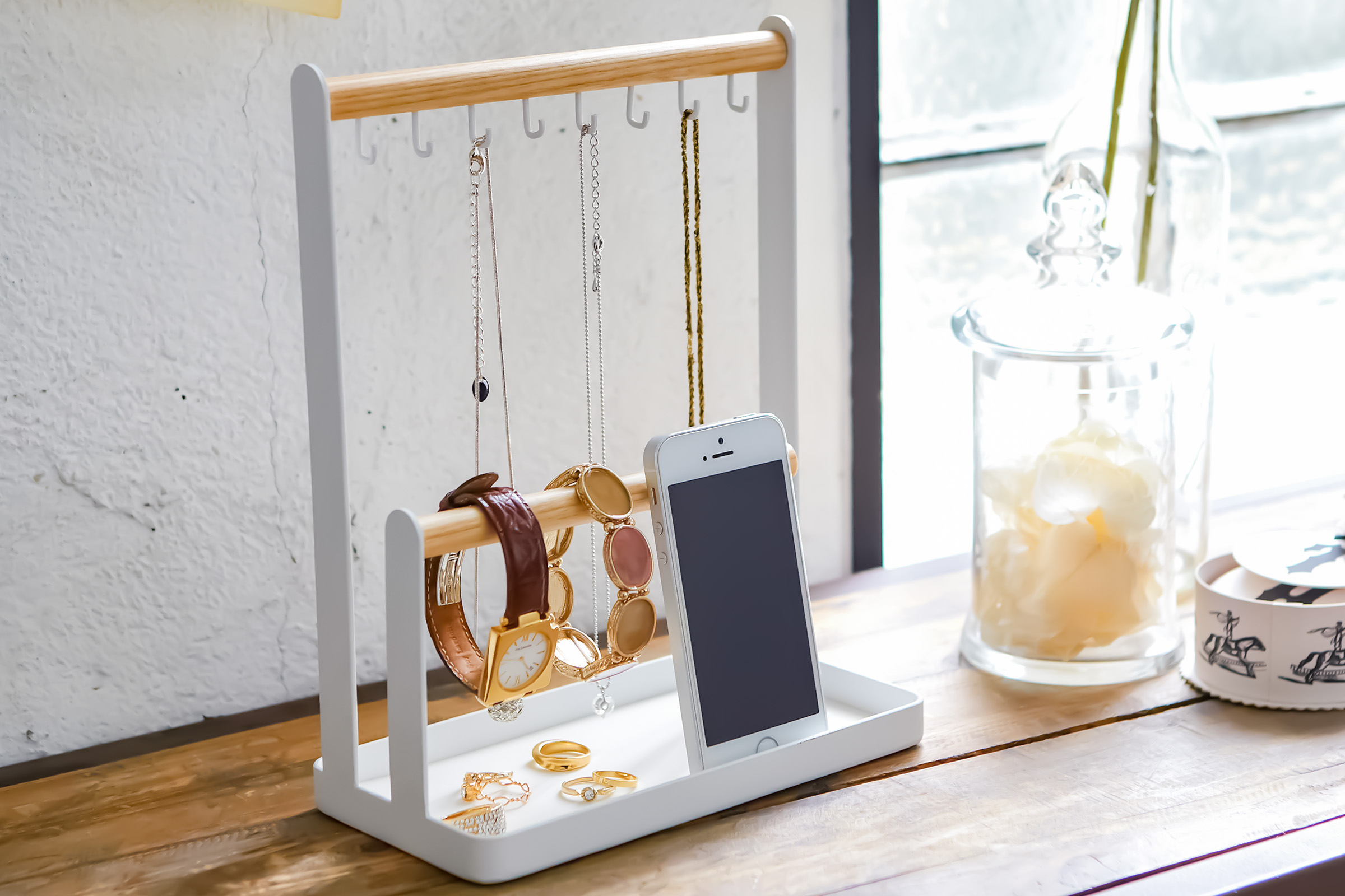 White Yamazaki Home Jewelry + Accessory Display with necklaces, watches and a phone displayed