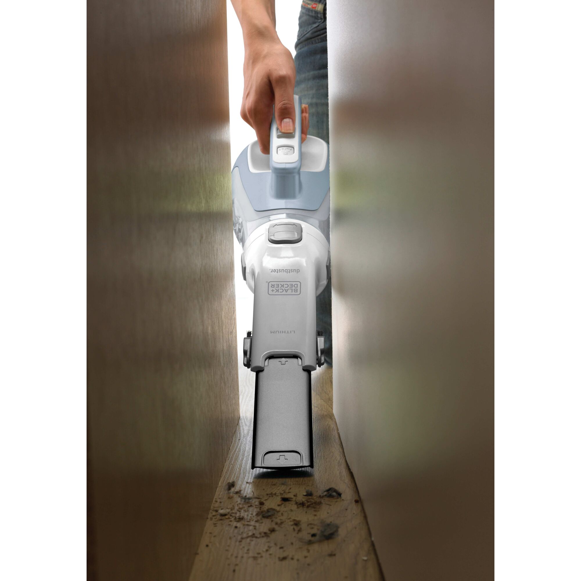 dustbuster Cordless Hand Vacuum being used to clean in difficult to reach place.