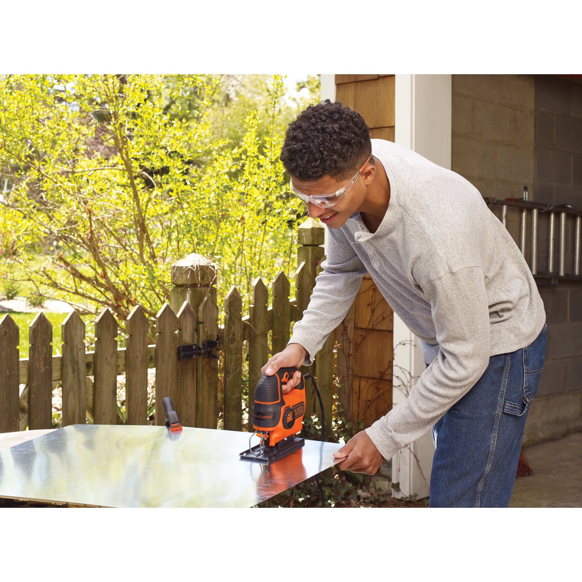 Black and decker jig saw smart select being used by a person.