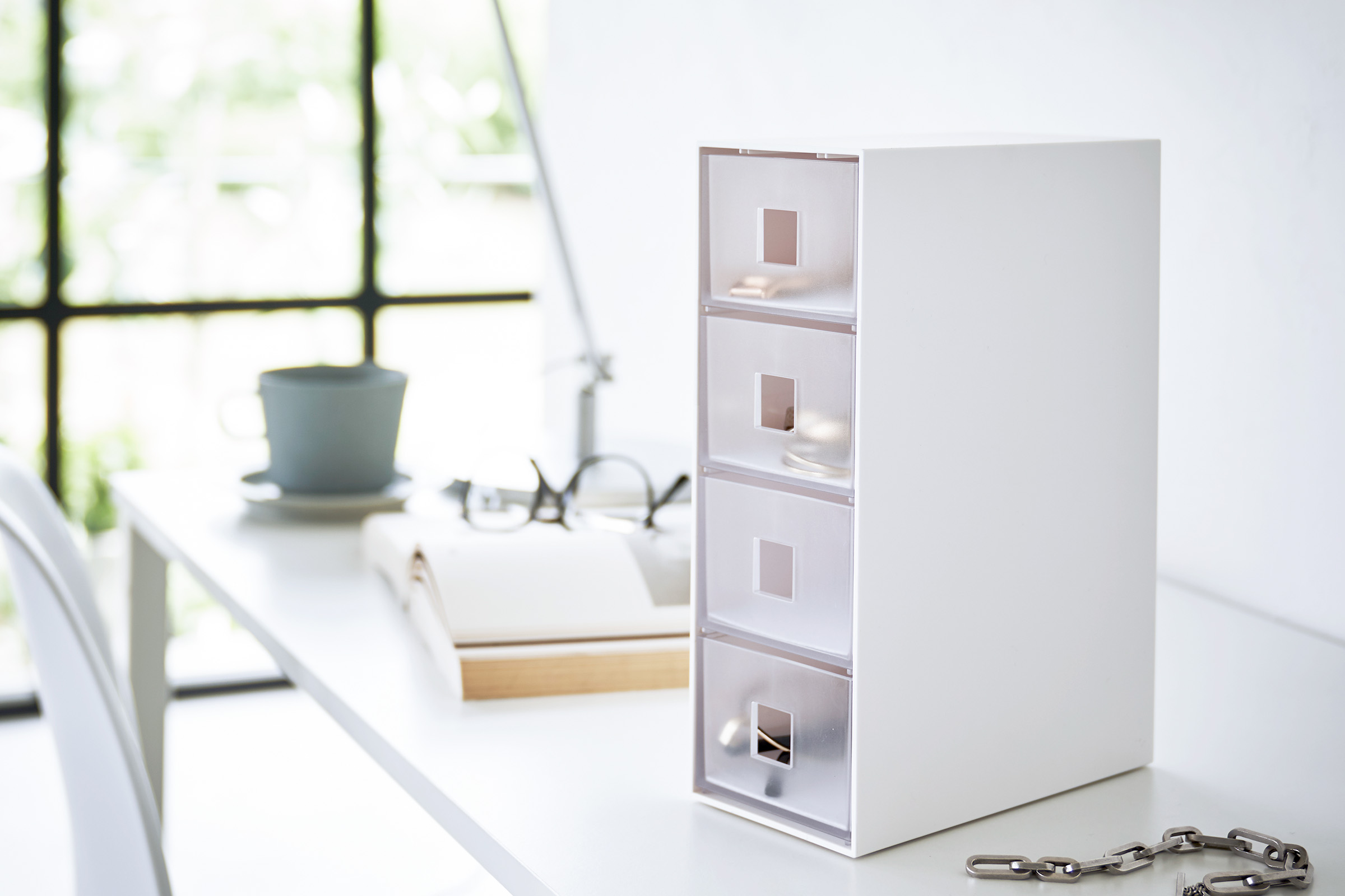 Storage Tower with Drawers by Yamazaki Home in white on a white desk in a well-lit room.
