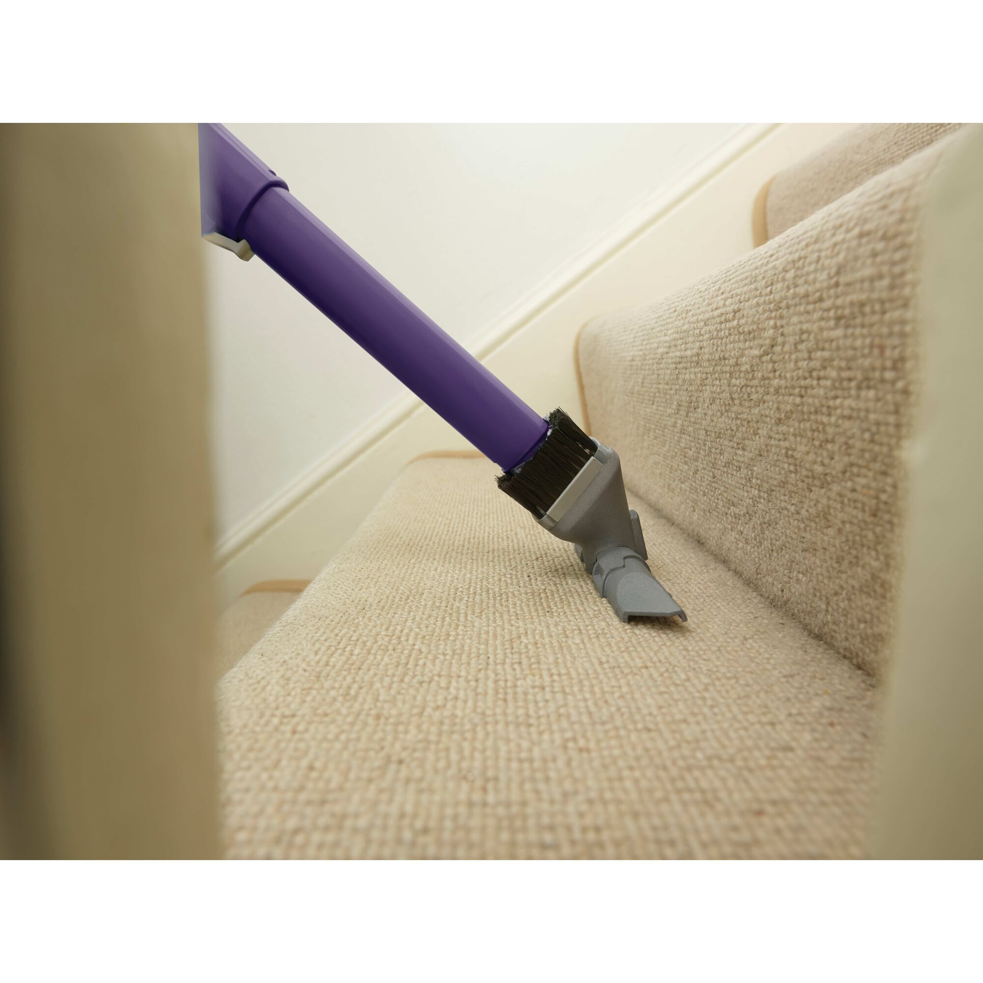 POWER SERIES PRO Cordless 2 in 1 Pet Vacuum being used to clean carpet on stairs.