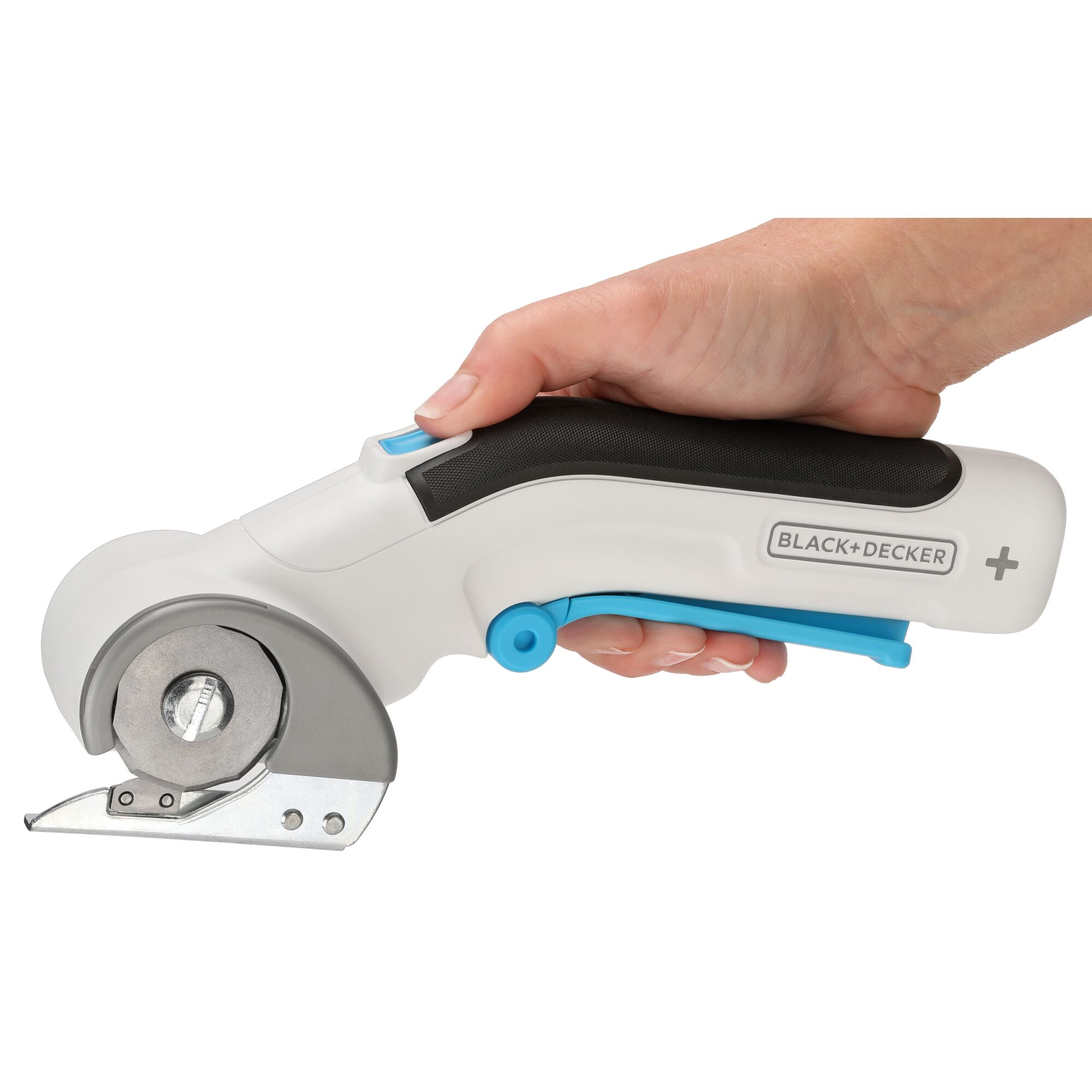 woman holding BLACK+DECKER cordless power rotary cutter with finger on safety lock