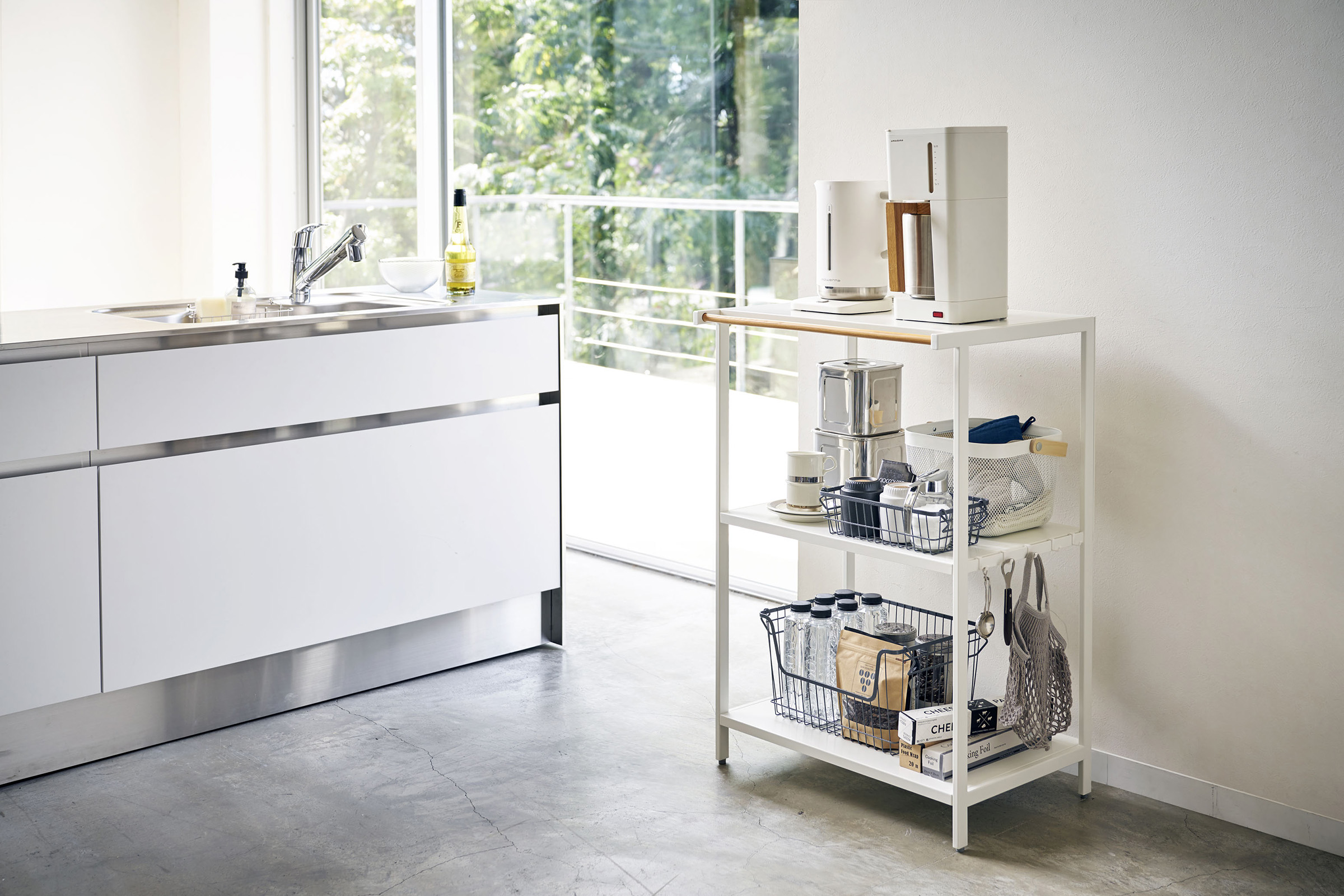 White Storage Rack holding coffee items and appliances in kitchen by Yamazaki Home.