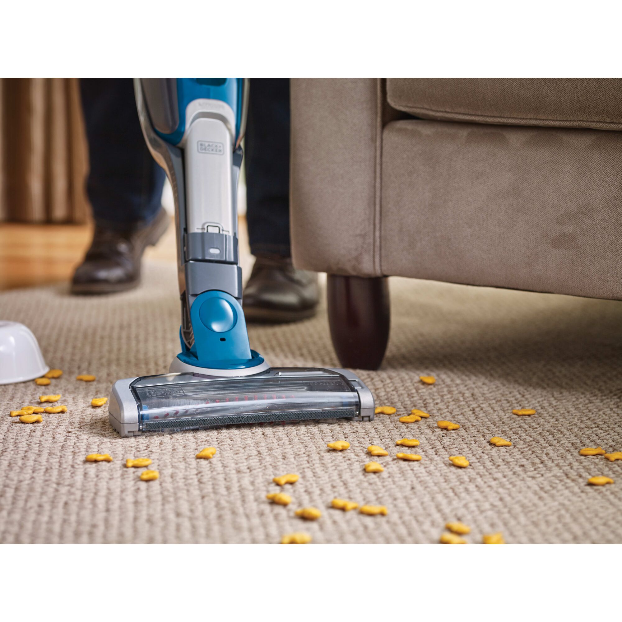 Cordless Lithium 2 in 1 Stick Vacuum being used to clean spilt food from carpet.