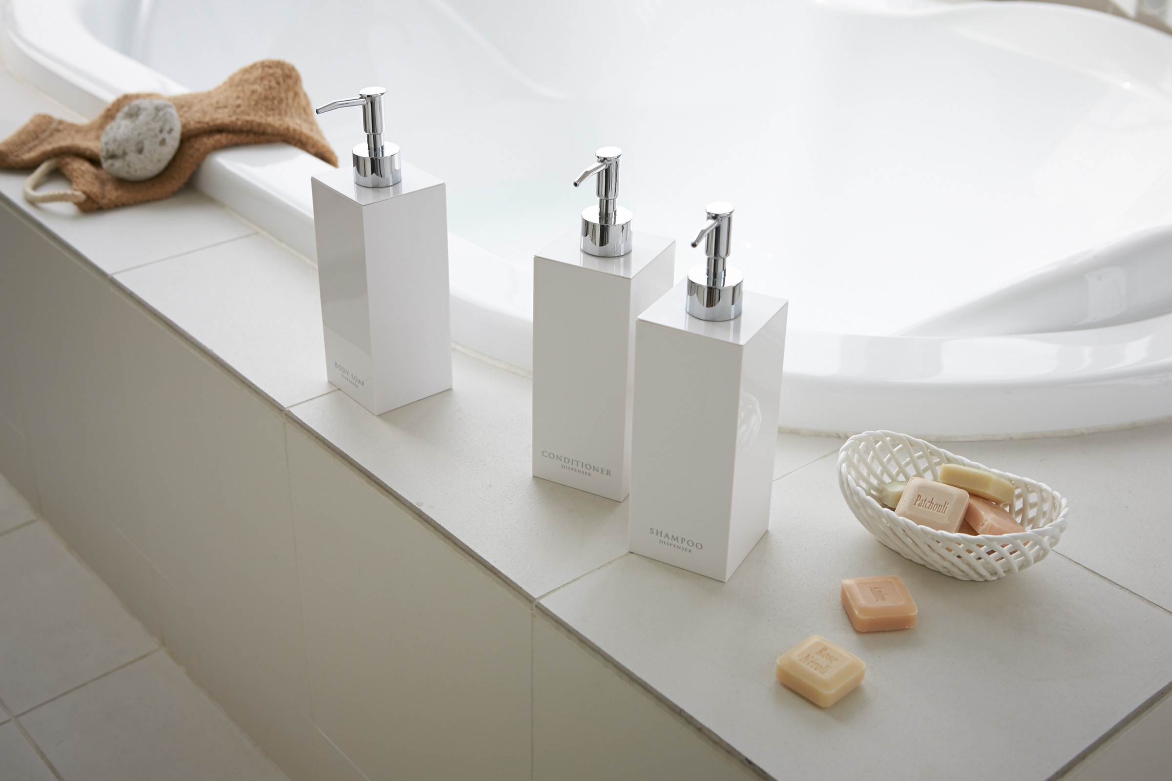 White Yamazaki Home Square soap dispenser in three styles by bathtub