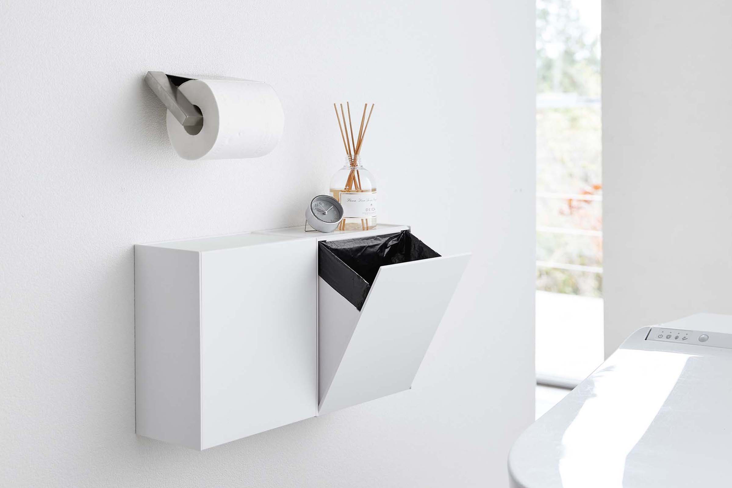 White Wall-Mount Storage or Trash Bin mounted on a wall in a bathroom