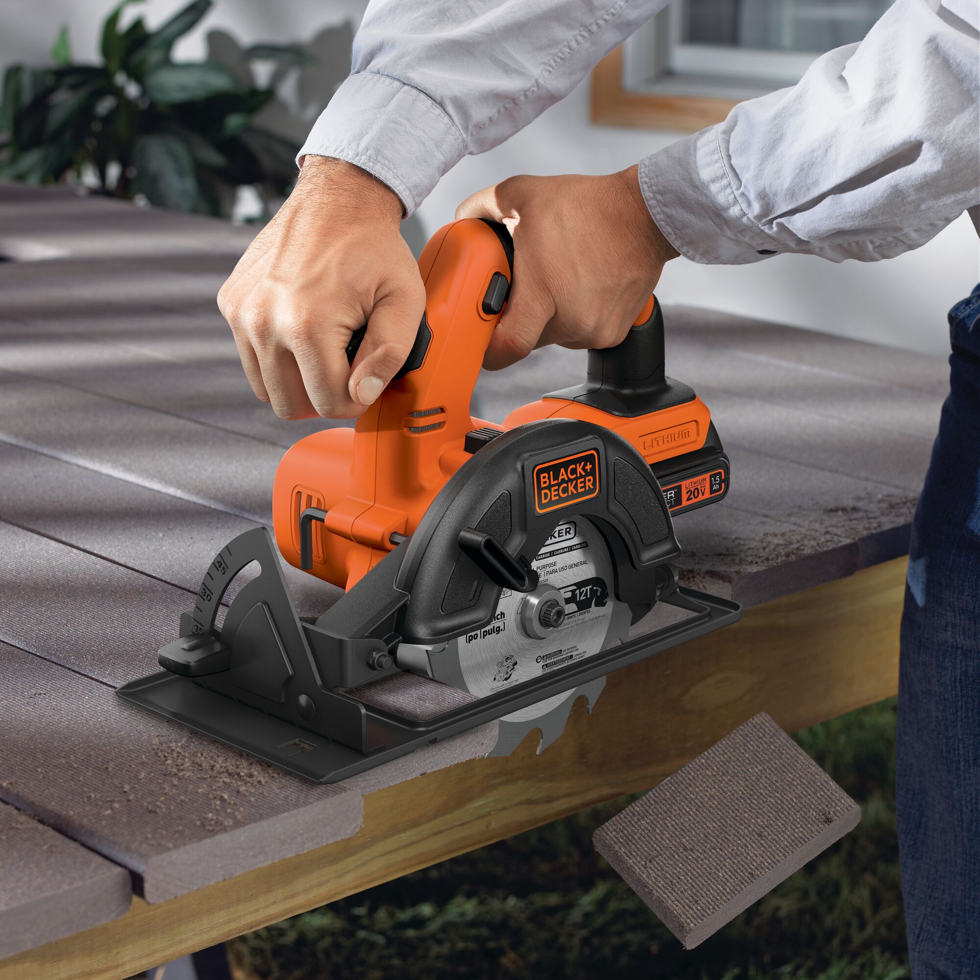 Black and decker 20 volt max lithium ion cordless circular saw being used to cut hard material