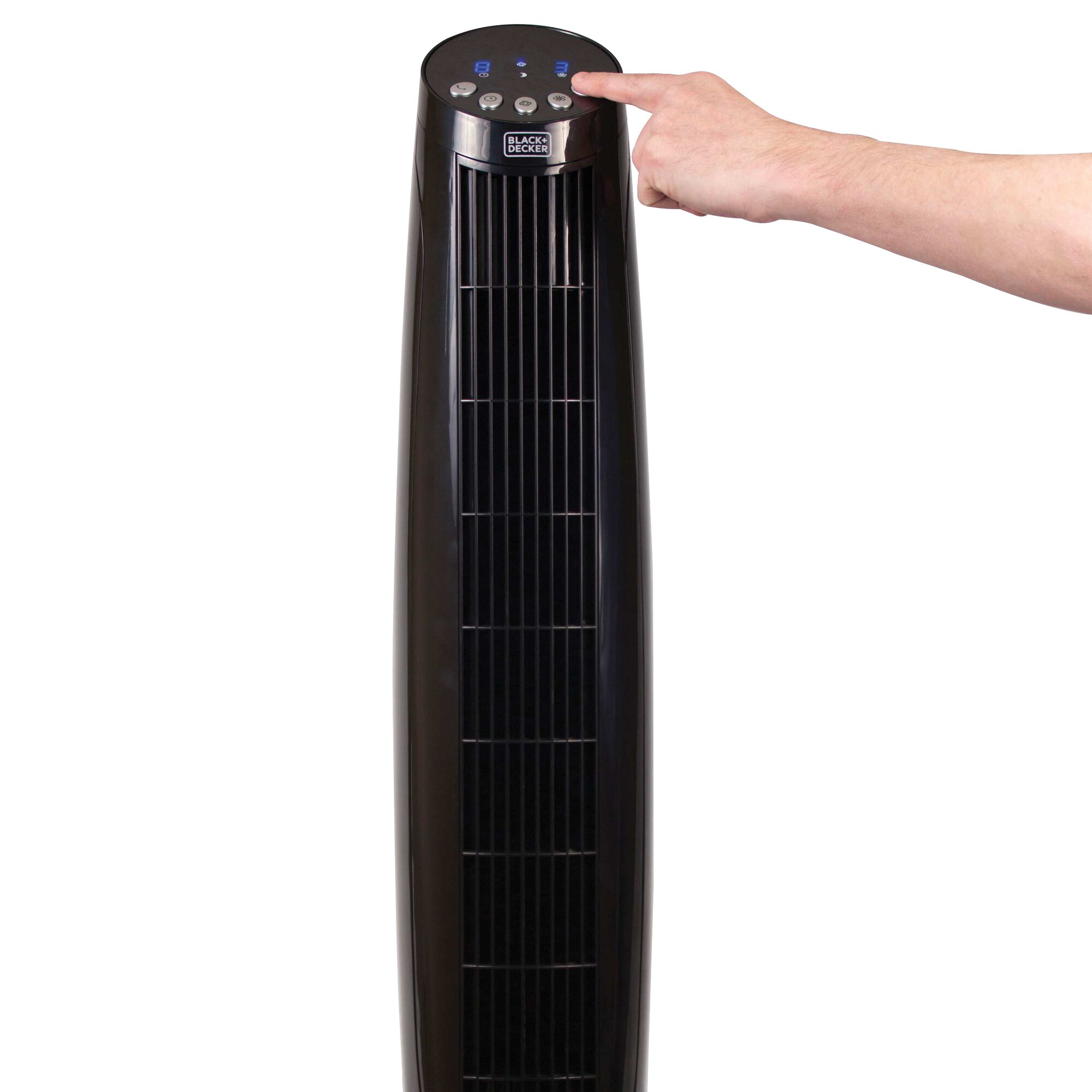 36 inch digital tower fan with remote being used by a person.