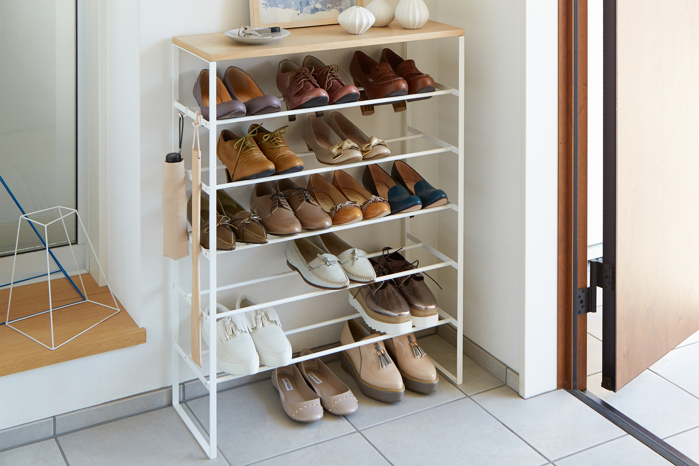 Yamazaki Home white 6-Tier Wood Top Shoe Rack holding shoes in entryway.