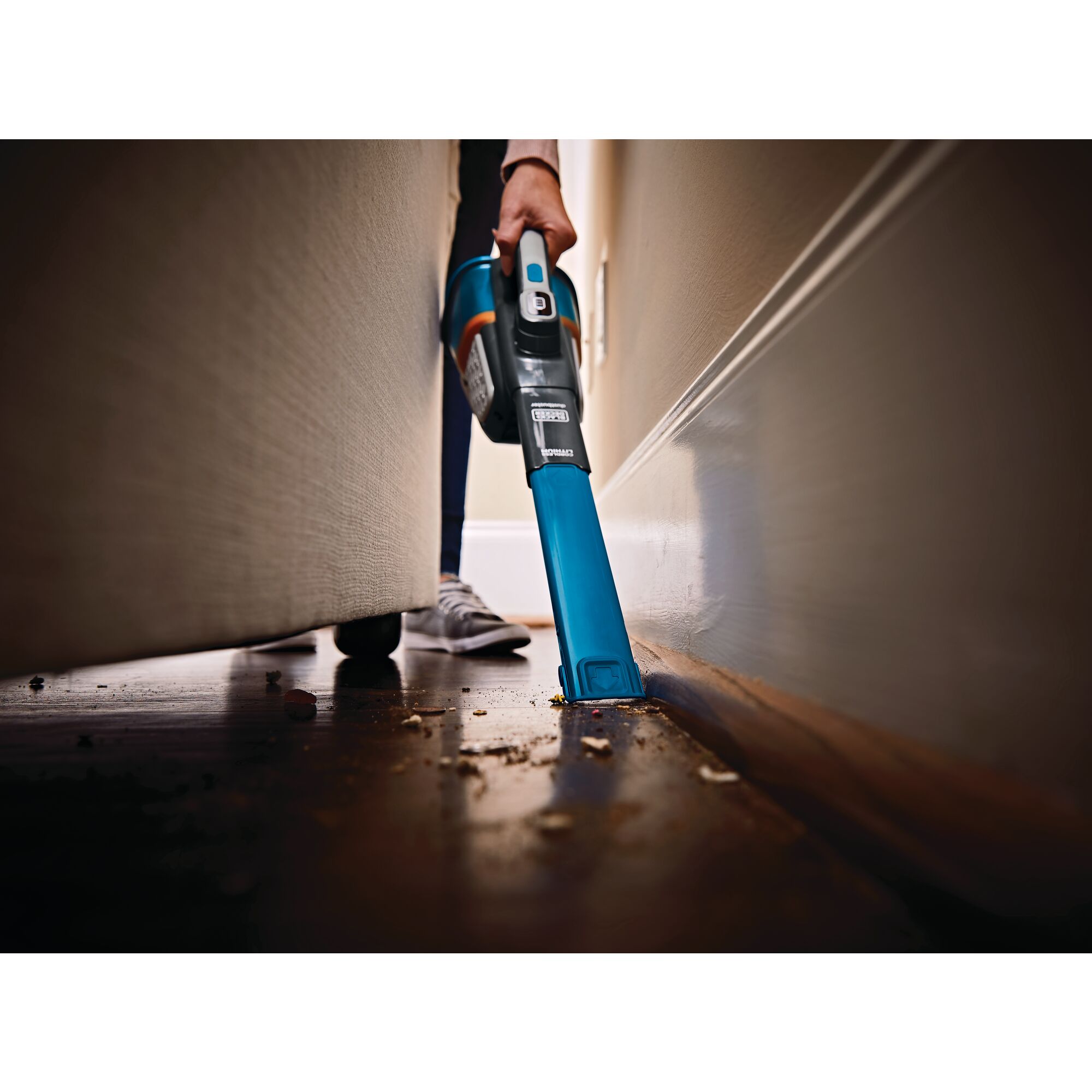 12 volt max dustbuster advancedclean cordless hand vacuum being used by a person.