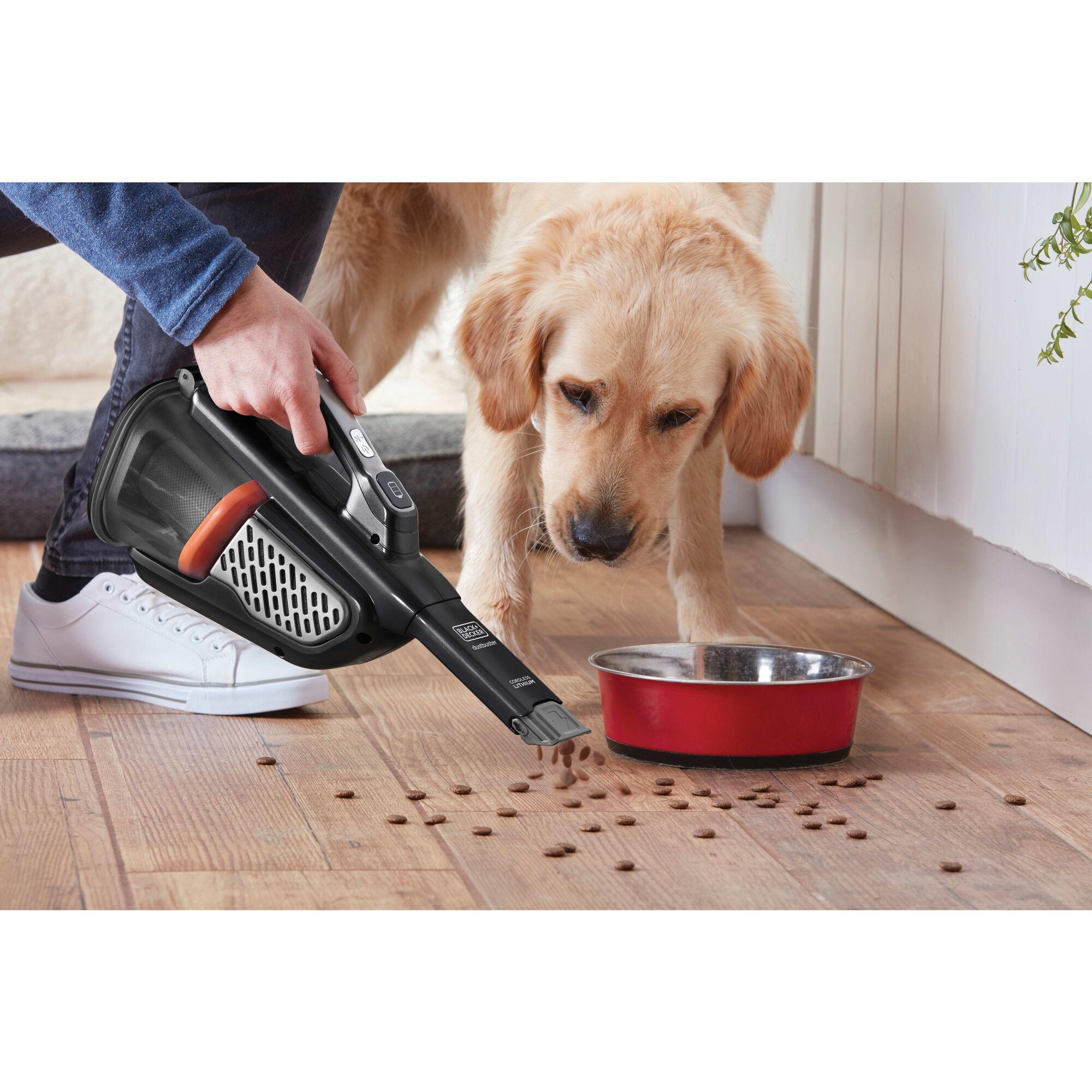 20 volt MAX dustbuster Advanced Clean cordless hand vacuum being used to clean dog food spillage on wooden floor.