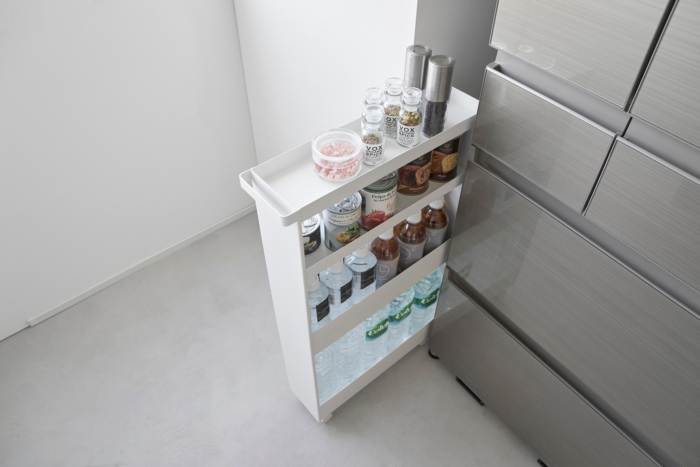 Top-down view of White Yamazaki Home Slim Rolling Cart holding food and drinks