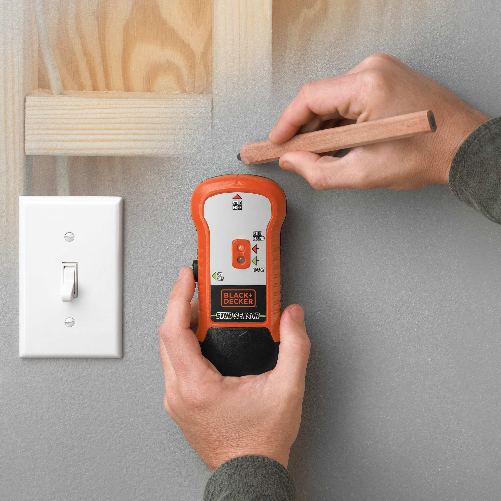 Stud Sensor being used on a dry wall.