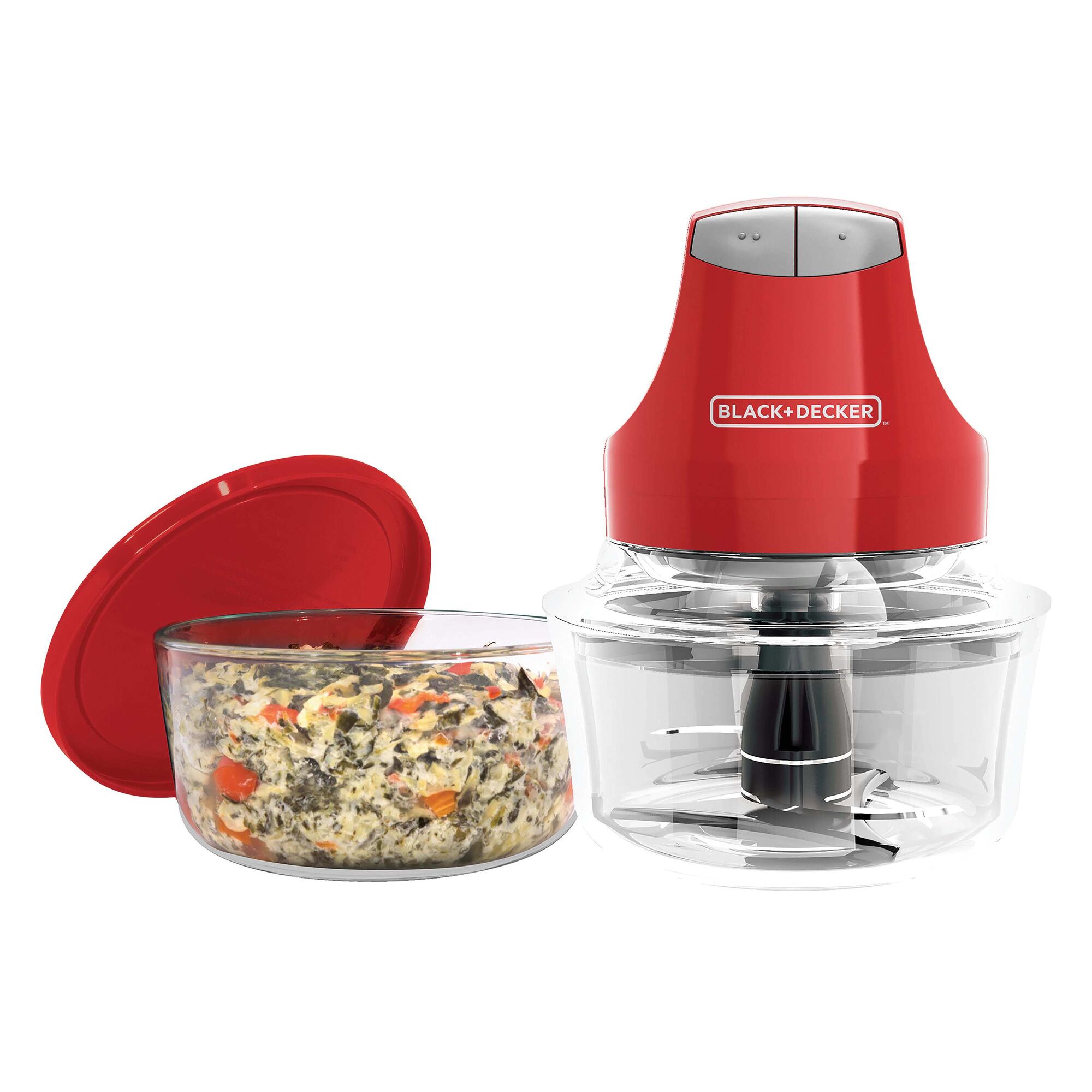 Glass bowl chopper with chopped vegetables.