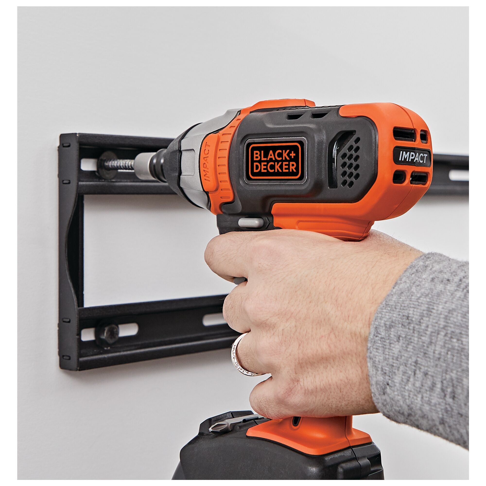 Cordless Impact Driver being used to install wall mounting bracket.