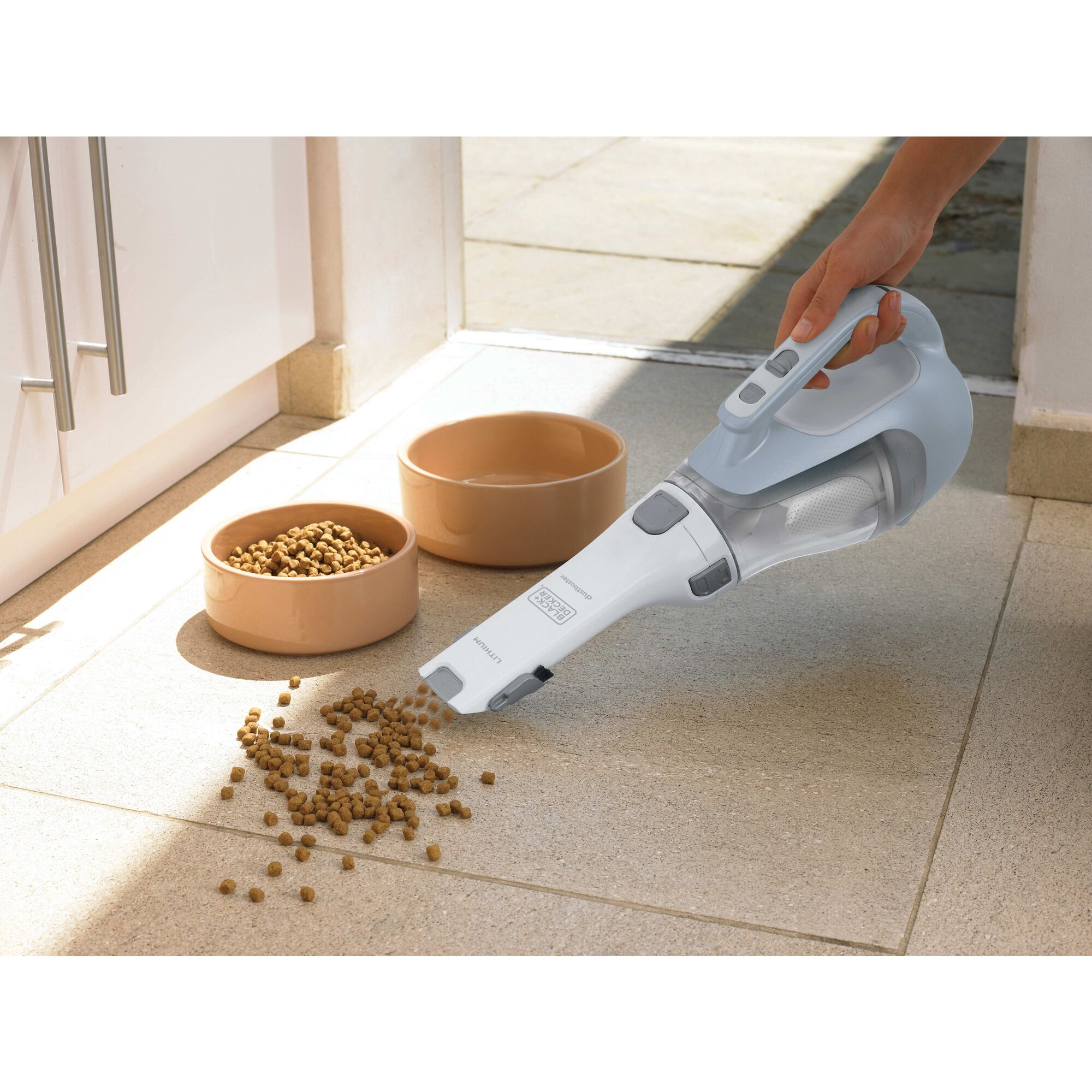 Dustbuster cordless hand vacuum being used by a person.