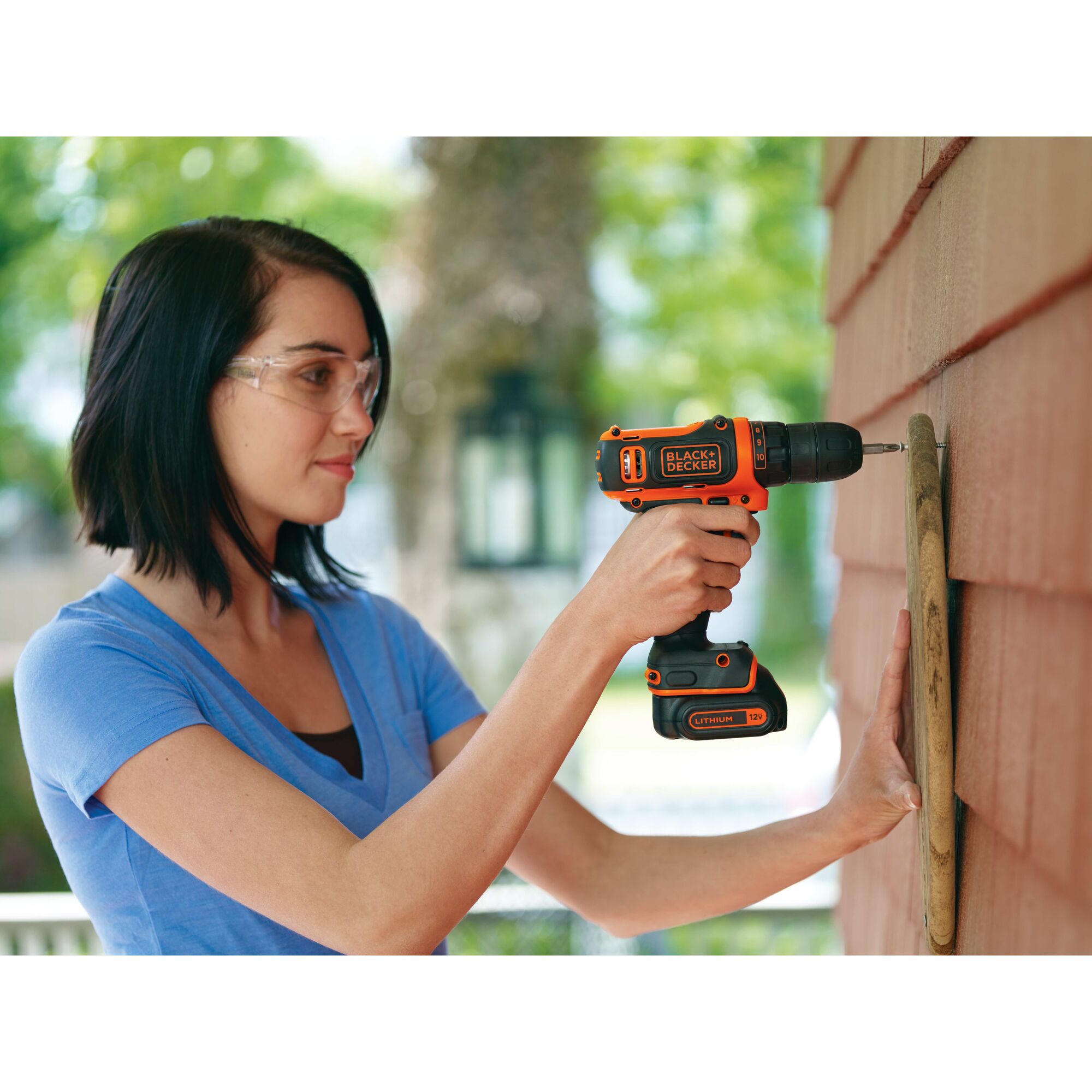 12 volt MAX cordless lithium drill driver being used by a person to drill a hole through wood.