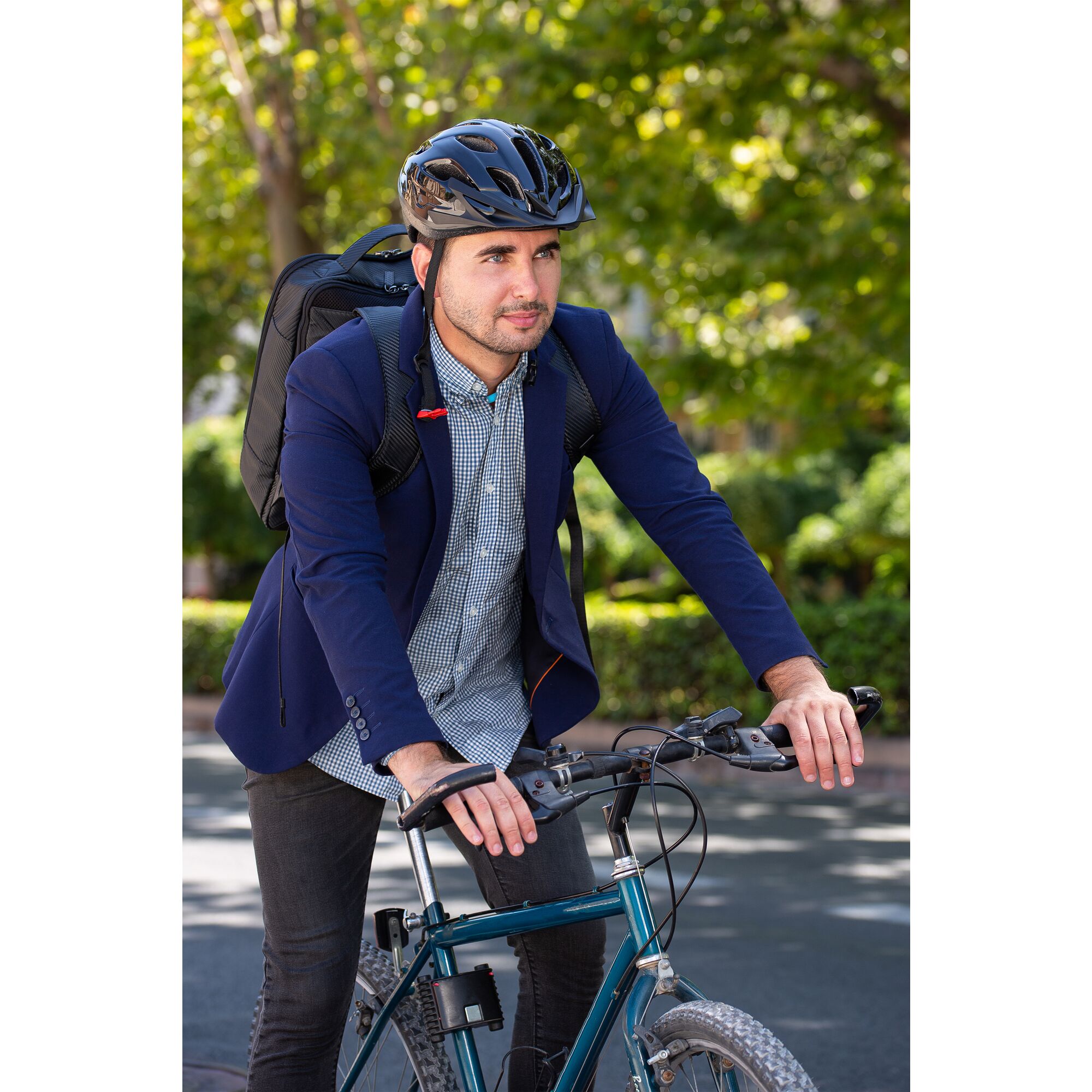 man wearing the comfortpak™ device in the breeze blue 360° lanyard as he bike commutes