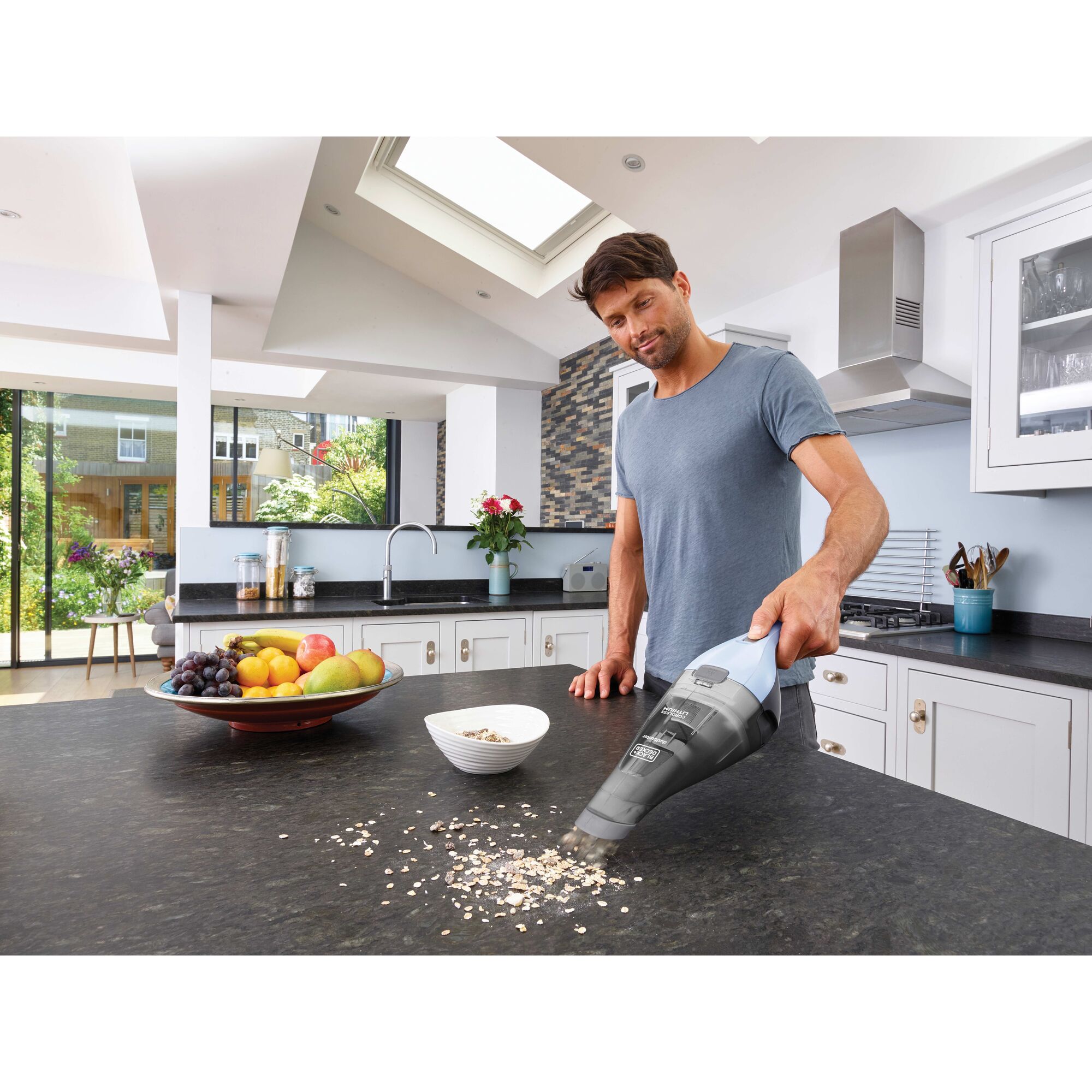 Dustbuster quick clean hand vacuum being used by a person to clean mess.\n