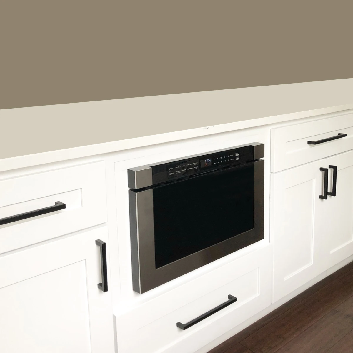 XO microwave drawer installed in white kitchen cabinetry