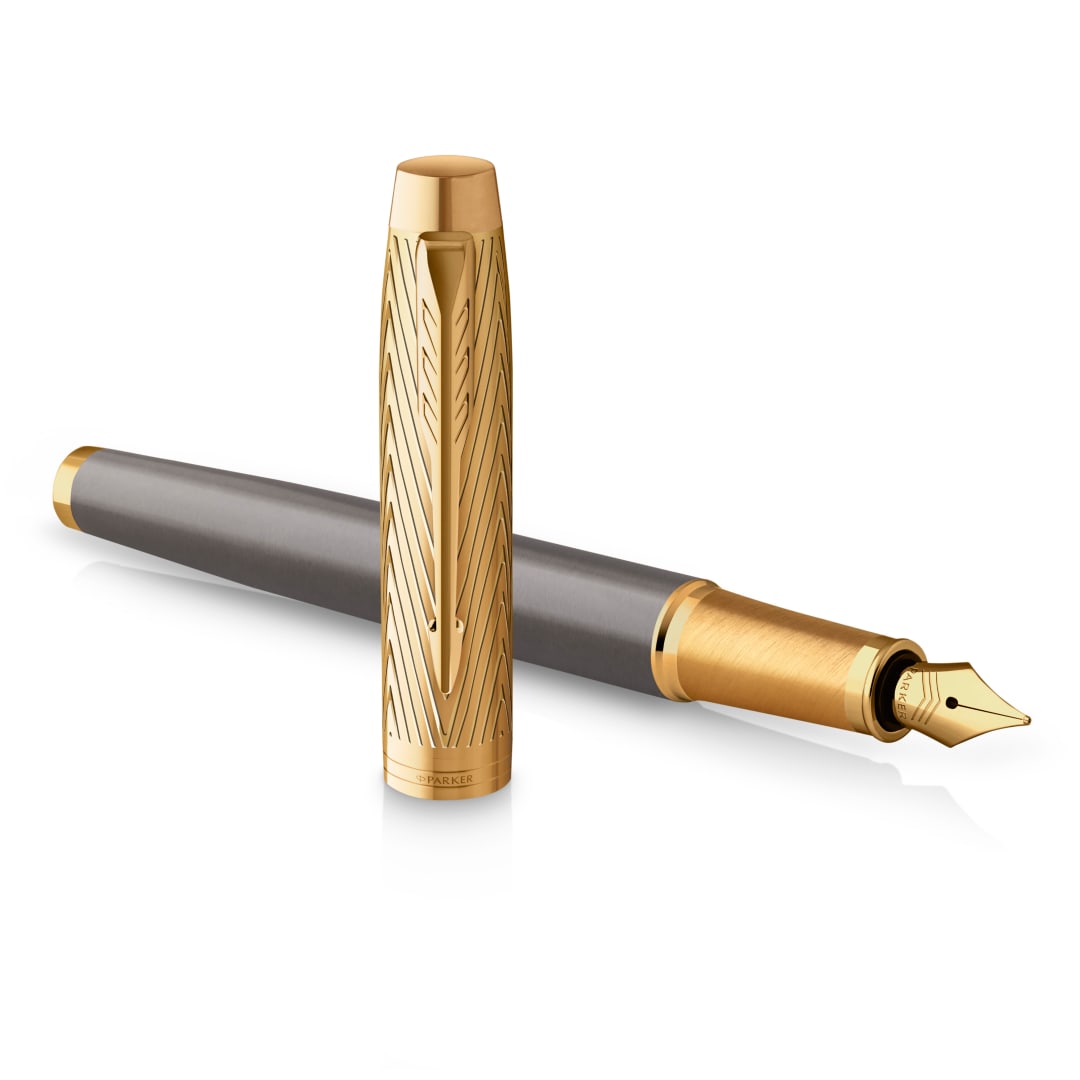 Pluma estilográfica Parker IM colección Parker Pioneerslacado gris con capuchón y acabados doradosplumín fino de acero inoxidabletinta azul