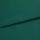 A folded teal-green woven fabric (linen texture) lies overlapping, the top edge forming a horizontal fold; close-up studio shot with even lighting and no visible background.