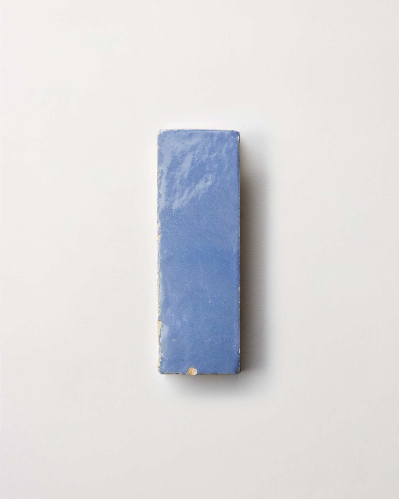 a blue tile on a white surface.