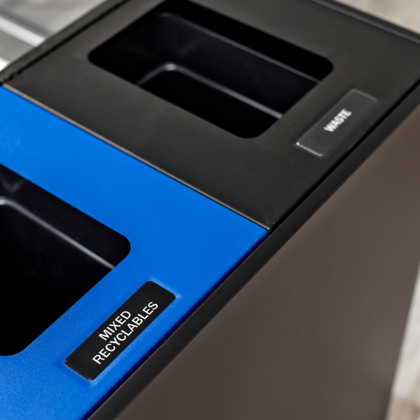 top view of a black powder coated steel mixed recyclables and waste container with color coded lids including lid labels