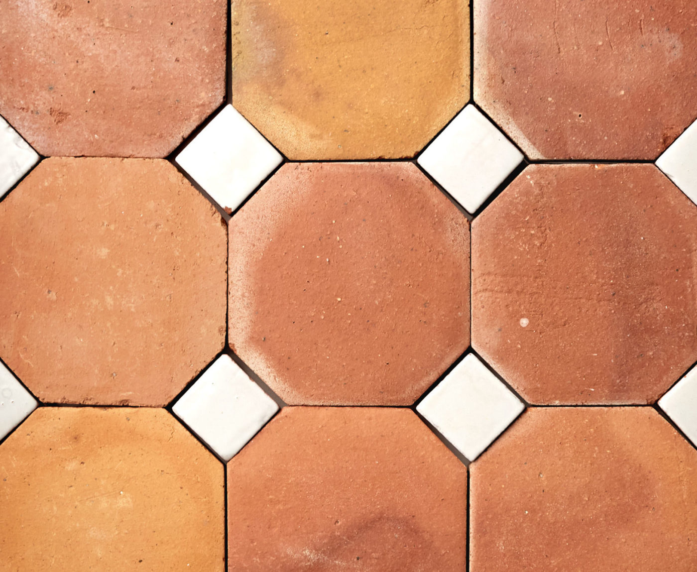 a close up of an orange and white tiled floor.