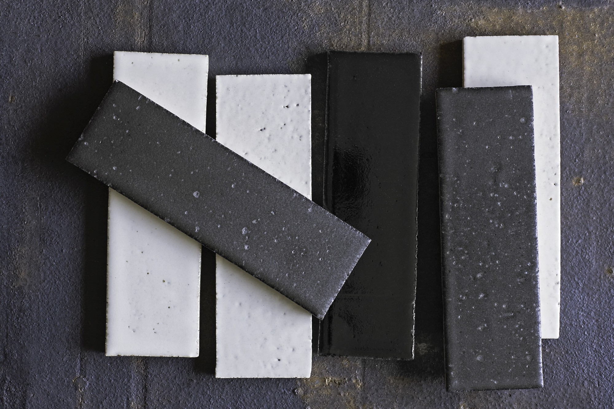 a group of black and white tiles on a wooden surface.