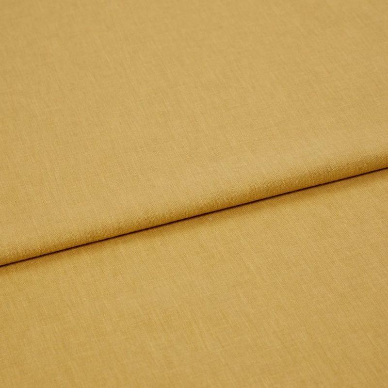 Mustard-yellow woven fabric panel, folded once with a visible overlapping edge, lying flat and smooth; close-up, studio-lit view emphasizing fine textile texture and warm, even lighting.