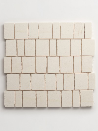 a white square tile on a white surface.