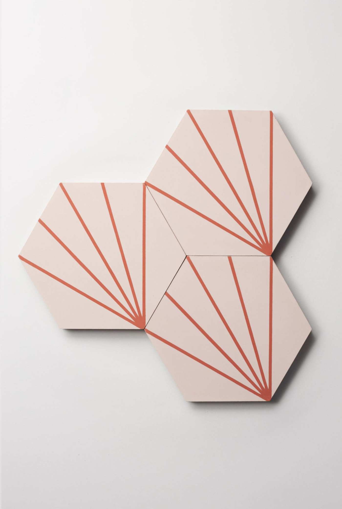 a set of pink hexagonal tiles on a white wall.