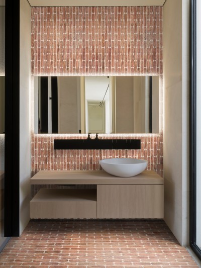 a modern bathroom with a brick wall.
