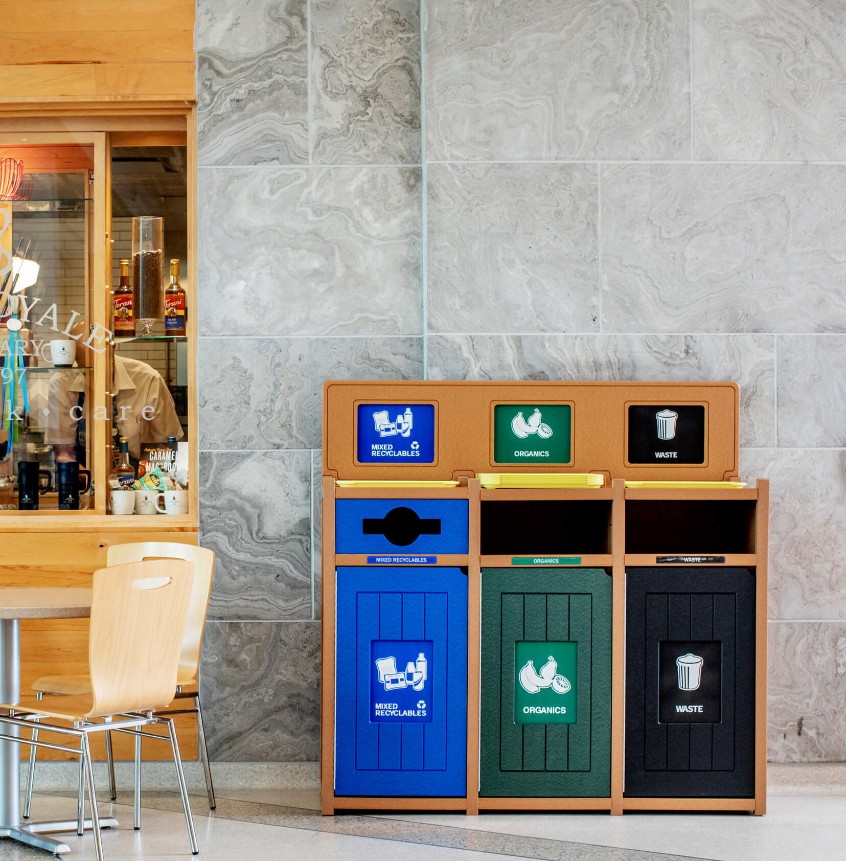 triple recycling organics and waste bin in a hospital food court