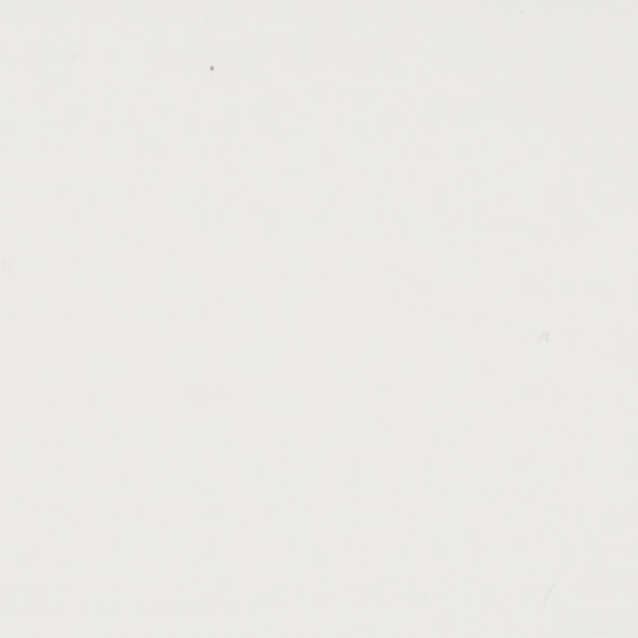 Off-white wall surface showing faint specks and tiny blemishes; evenly lit, minimal visual detail suggesting a neutral, well-lit interior space.