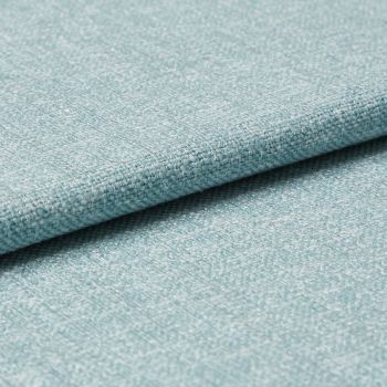 Light-blue woven upholstery fabric folded so one edge overlaps, revealing tight textured weave; photographed as a close-up on a flat surface with soft, even studio lighting for a material sample.