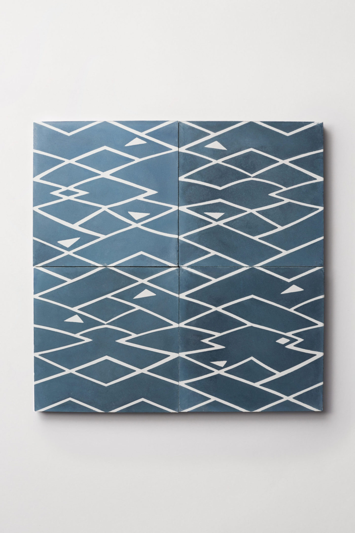 four tiles with blue and white patterns on them.