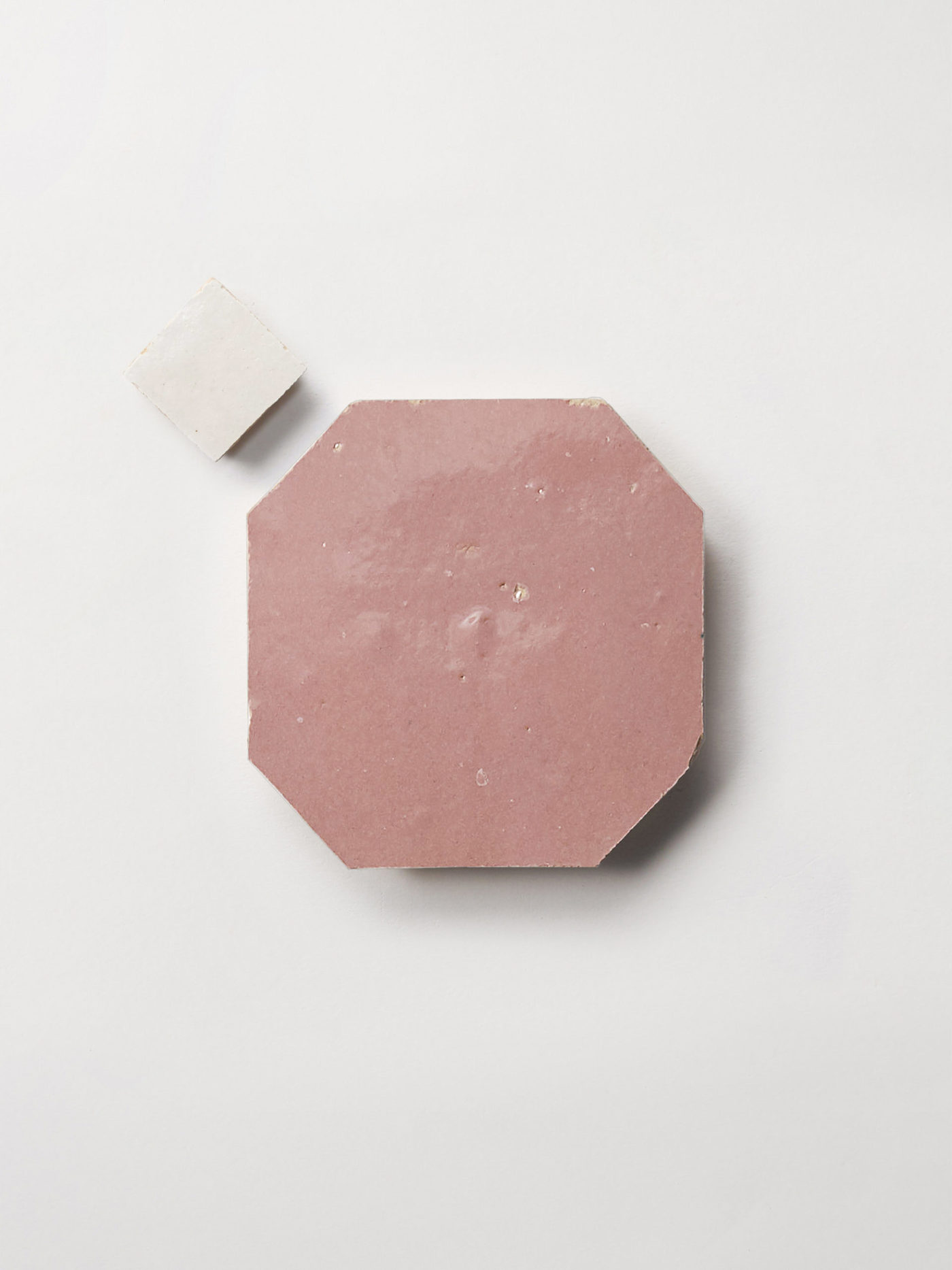 white and pink tiles on a white surface.