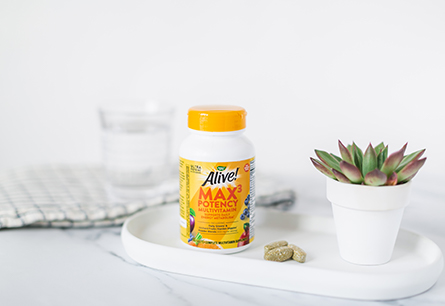 Bottle of Alive Multivitamins Max3 with no iron on white tray with succulent.